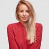 Woman wearing a red blouse against a light gray background